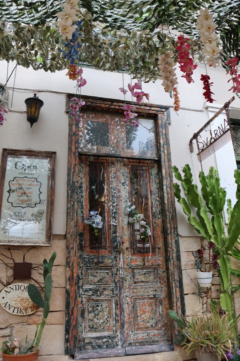 Schmucke alte Doppeltür eines Antiquitätengeschäfts in einer schmalen Gasse der Stadt Ägina